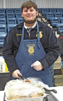 Brody Cromes serves the pork chops at the Coyle Pork chop Feed Feb.4. Photos by Mike Monahan