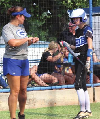 by Mike Monahan Assistant Coach Kara Tarrant gives hitting tips
