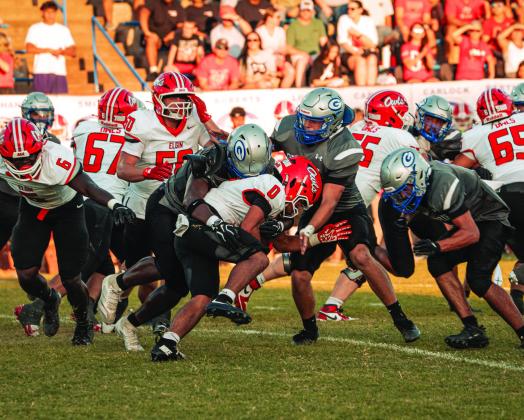 A group of Bluejay defenders bring down an Elgin ball carrier at Jelsma Stadium on Friday, Sept. 4. Guthrie held the Owls to 115 rushing yards, a week after Elgin ran for 300. Photo by Reece Heck