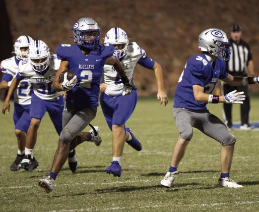 Guthrie’s Skylor Scamman (2) breaks into the open as Cade Carey (36) blocks and Noble’s Henry Cook (30) gives chase during the first half of Guthrie’s 28-21 win on Friday, Oct. 23, 2026, at Jelsma Stadium in Guthrie. Photo by Brent Fuchs.