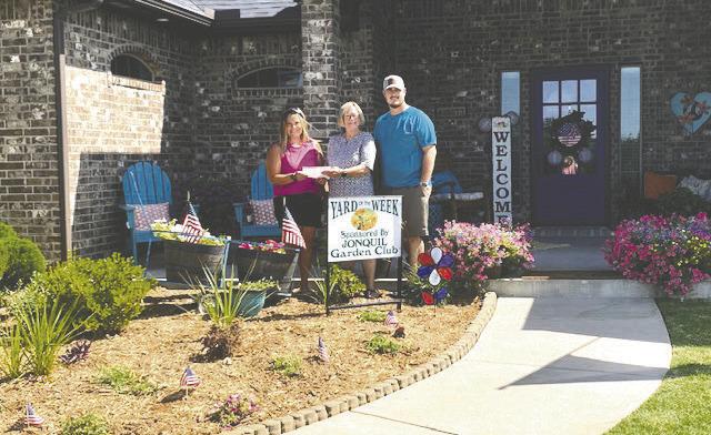 Jonquil Garden Club has selected Nick and Kaylee Abbott at 5865 Cimarron Circle for Yard of the Week. Pictured L to R: Kaylee, Linda Perkins, Club Member, and Nick.