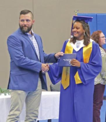 Aubrey Taylor recieves her diploma from John Pross
