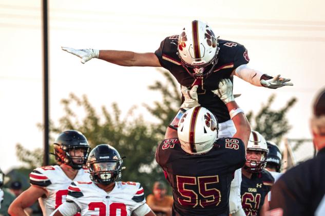 A Cashion player is lifted by a teammate in celebration during the Wildcats' 37-14 Week 1 win over Crescent on Friday, Aug. 28, in Cashion. Photo by Reece Heck.