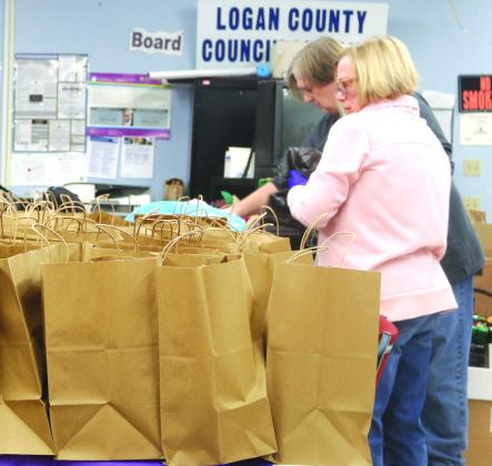 Pictured Above, The Logan County Council on Aging ( A local United Way partner agency) delivered 50 Ham Christmas dinner bags to seniors in Crescent, Guthrie, and Langston on December 13. The council had a similar project at Thanksgiving with turkeys. Food item were donated by Golden Chick, EMI, God’s Food Bank, and Crescent Food Bank. Every bag had ham, scallop potatoes, vegetables, dinner rolls, stuffing, pumpkin pie and a gift card to Dollar General or Cash Savers.