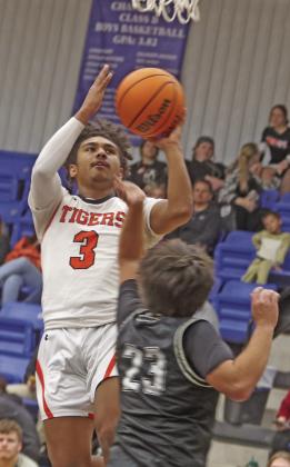 PHOTO AT LEFT: Crescent’s Zori Wilson works to get around Okarche defender. PHOTO AT RIGHT: Crescent’s CJ Wilson drives to the basket in the Tigers 75-65 win over Oilton on January 18.