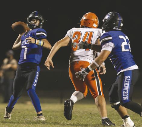 Coyle quarterback Ticen Hock throws a pass as James Lackey, right, blocks Yale’s Cody Whitington during the Bluejackets’ homecoming game. Coyle won 30-8. Photo by Brent Fuchs