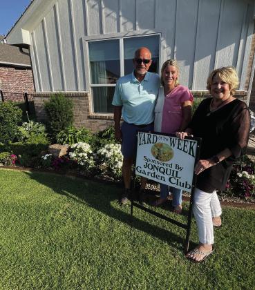The Jonquil Garden Club is pleased to announce another beautiful yard of the week. Pictured L to R: Mike &amp; Leigh Ann Baldwin, 1601 Porter Street &amp; garden club member Dana Bertrand.