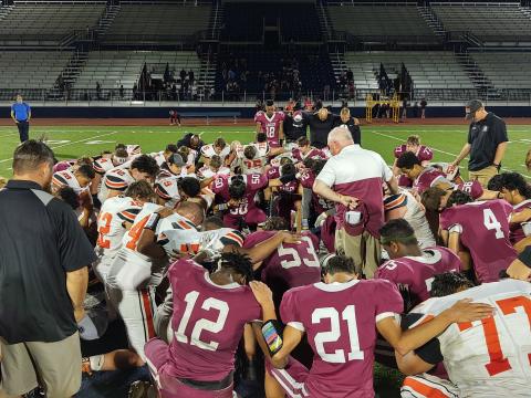 OCA and Crescent players gather for a postgame prayer