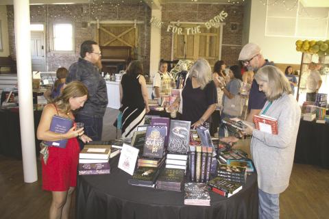 Shoppers browse hundreds of books during CASA for Kids' third annual Grown Up Book Fair at the Guthrie Depot on July 23. Photo courtesy of CASA For Kids.