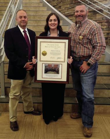 Alyssa Cardenas, a Logan County Sheriff’s Office investigator, celebrates completing the Oklahoma State Bureau of Investigation Agents Academy. Cardenas is pictured at graduation with Logan County Sheriff Damon Deveroux and Captain Bragg.