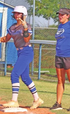 Haley Gallo at first base with Coach Kara Tarrant after base hit