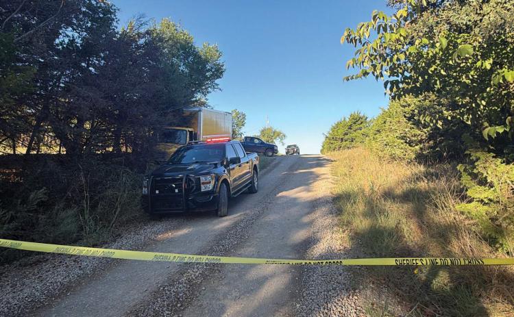 Law enforcement vehicles and police tape mark the scene Monday morning near the 11000 block of East College Avenue and Autumn Woods Farm Road following a deadly altercation involving two delivery workers. One person was killed and another was injured in the incident. Photo courtesy of Logan County Sheriff’s Office.