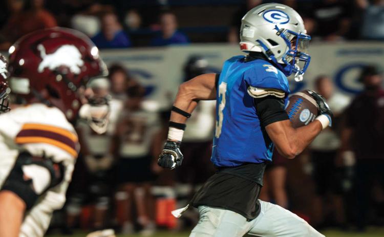 Guthrie’s Codie Carlock (3) runs away from Blanchard defenders on his way to a touchdown at Jelsma Stadium on Friday, Sept. 18. The Bluejays won 49-7. Photo by Reece Heck