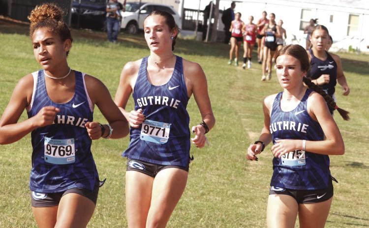 Guthrie XC Jaidence Foster (9769) Raley Hooper (9771) and Peyton Read (9775) run together as they head for finish line.