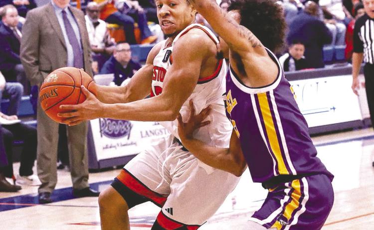A Langston player drives past an Eastern Oregon defender during the basketball game on March 14. Photo courtesy Langston University Facebook page