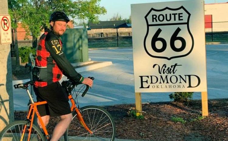 Cyclist by Route 66 sign