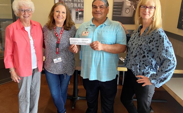"Guthrie Lions Club members Sylvia Ochs (left) and LeAnn Ramsey (right) present a "promissory note" for $450 to Guthrie Hope House representatives; Natalie Cunningham (center), Women's Facility Director and Frankie Garcia (center), Program Administrator."