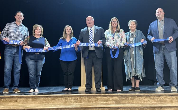 Collateral Elementary Schools opens its doors with a ribbon cutting ceremony on the evening of Thursday, March 13, 2025. Left to Right: Chris Schroder, Tina Smedley, Janna Pierson, Mike Pierson, Leslie Cotton, Gayle Davis, Ron Plagg. Photo by Bobbi Waddell