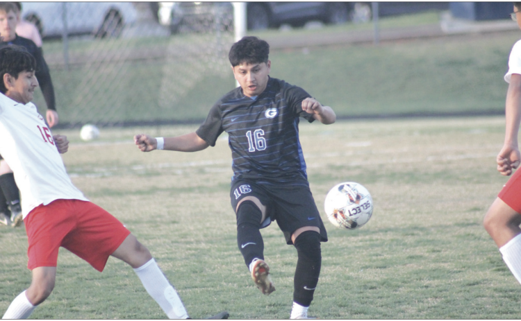Guthrie's Adrian Gonzalez fights for a ball against Del City, March 31. Photo by George McCormick.