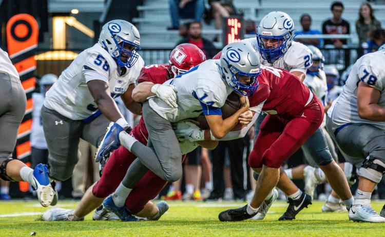 Guthrie Running back Elijah Smith tries to spin away from Tuttle tacklers during the Bluejays' 38-13 seasoning-opening loss Thursday.