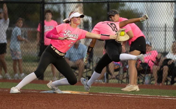 Crescent Lady Tigers first baseman Ava Beaty, No. 22, reaches for the tag on Cashion’s Lily Stuemky, No. 18, during their pink out game on Sept. 15. Photo by Brent Fuchs