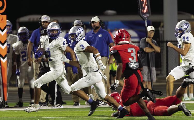 Guthrie’s Skylor Scamman, left, carries the ball with teammate Codie Carlock running alongside during Guthrie’s game at Carl Albert in Midwest City. Photo by Brent Fuchs.