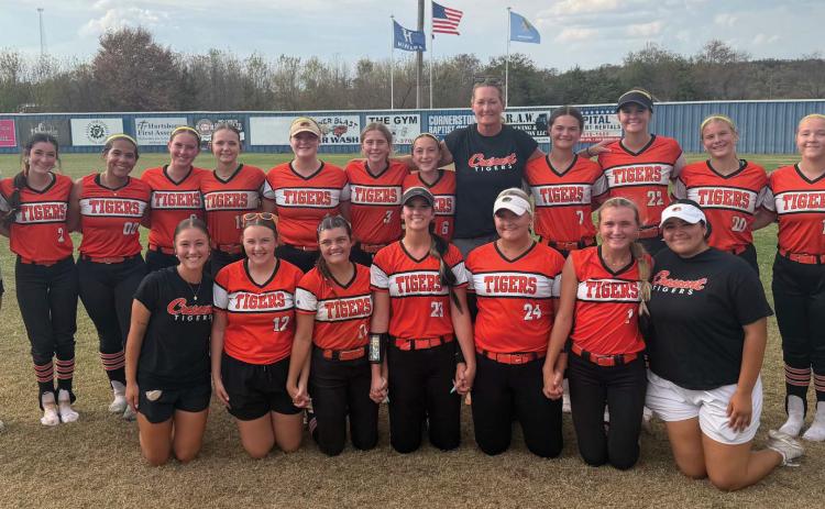 Crescent’s Lady Tigers are all smiles after defeating Hartshorne to earn a berth in the Class 2A state fast-pitch softball tournament. The victory capped a dramatic day for the Tigers, who defeated Hartshorne twice to claim the super-regional championship and advance to the state tournament in Shawnee. Photo by Emily Williams
