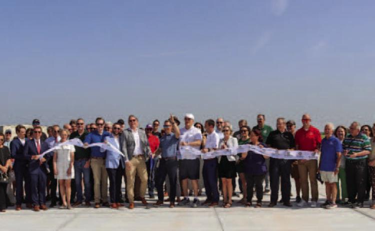 Airport officials, elected leaders and community members celebrate the completion of the Guthrie Edmond Regional Airport Taxiway Realignment Project during a ribbon cutting on the newly constructed taxiway June 30. Photo courtesy of the City of Guthrie.