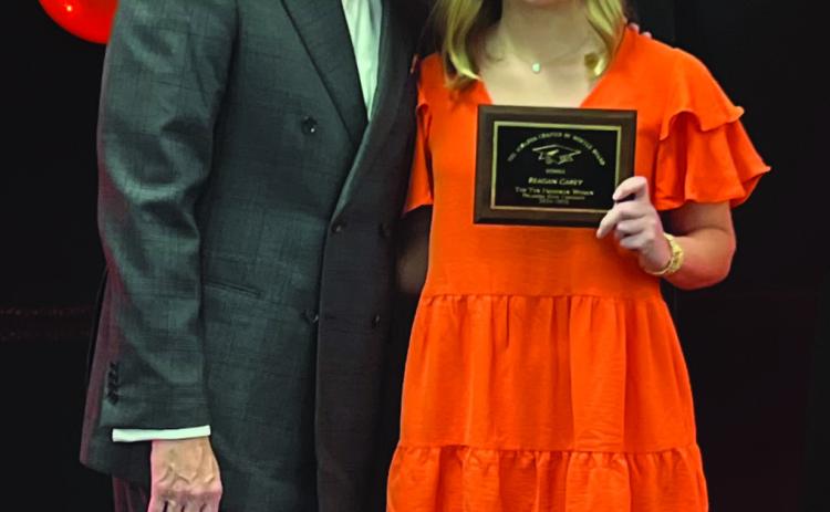 Reagan Carey accepts the Top Ten Freshmen Women award from OSU President, Dr. Jim Hess. Photo Submitted.