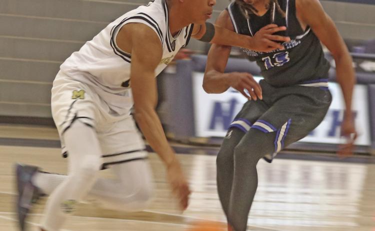 Braydon Morgan plays some tight defense against Midwest City.