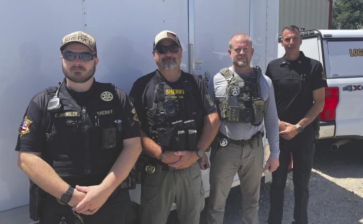 Logan County Sheriff’s Office along with the U.S Marshalls prepare to conduct compliance checks during Operation Adam’s Watch. Deputies visited registered sex offenders throughout the county to verify addresses and ensure required registration information was current. Photo by Nikki Bos