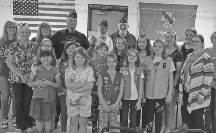 VFW Post #4578 Commander, Nicholas Erwin and other officers holding a check that was donated to Girl Scouts Western Oklahoma Troop 3005. After receiving the check, the girls voted to use some of the proceeds to make Birthday Boxes for House of Jesus, so that children who can’t afford a birthday can still celebrate.