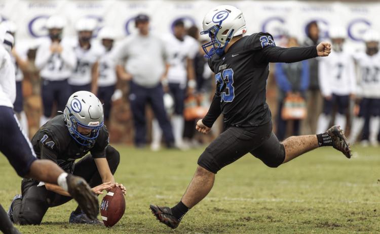 Guthrie kicker Ceasar Lopez attempts an extra point against Altus as Daelon Rice holds. The Bluejays came from behind to win.