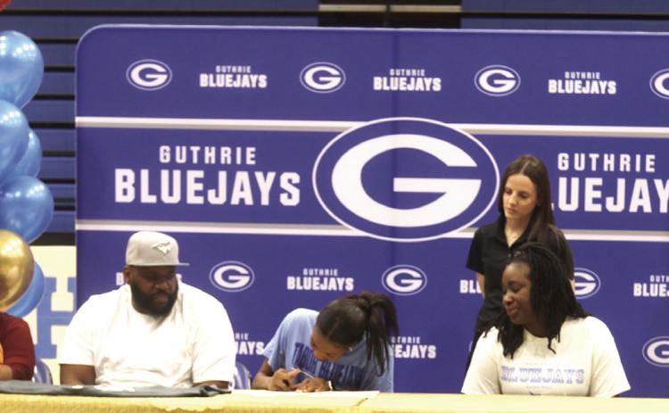 Pictured above, Guthrie Senior Ania Morgan signs a Letter of Intent to play basketball next year at Tabor College in Kansas. Family, Friends and teammates were present for the signing on April_ . Photo by Mike Monahan