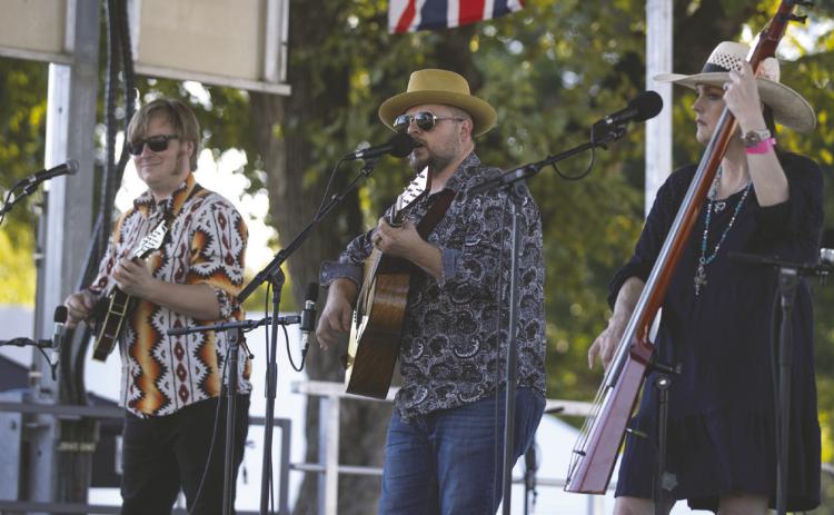 Rick Faris, center, performs with his band Friday on the Byron Berline Main Stage at Oklahoma’s International Bluegrass Festival in Guthrie. Faris, who first played the festival in 2010, credited the late Byron Berline’s friendships with musicians around the world for the festival’s international lineup. “It’s a legendary festival, but also the fun that we have in the campground with jamming and hanging out with friends,” Faris said. Photo by Brent Fuchs