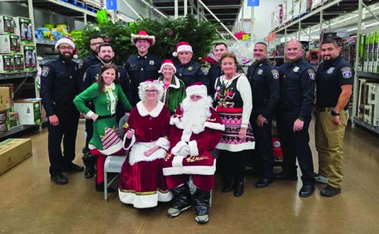 Guthrie Police Officers with Santa and Mrs. Claus at the annual Shop with a Cop event. Photos courtesy Guthrie Police Department.