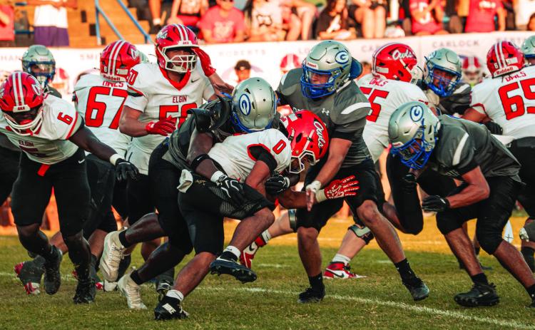 A group of Bluejay defenders bring down an Elgin ball carrier at Jelsma Stadium on Friday, Sept. 4. Guthrie held the Owls to 115 rushing yards, a week after Elgin ran for 300. Photo by Reece Heck