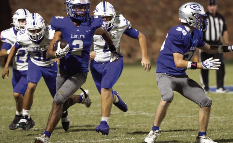 Guthrie’s Skylor Scamman (2) breaks into the open as Cade Carey (36) blocks and Noble’s Henry Cook (30) gives chase during the first half of Guthrie’s 28-21 win on Friday, Oct. 23, 2026, at Jelsma Stadium in Guthrie. Photo by Brent Fuchs.