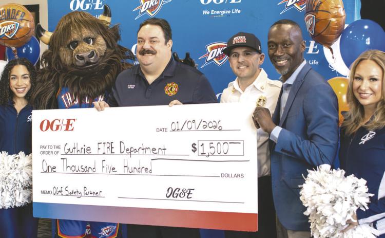 Thunder Girl Tamia Piazza, Rumble, Guthrie Fire and EMS Captain Ryan Reeves, Chief Dane Lausen, OG&E Community Affairs Manager Spencer Browne, and Thunder Girl Zoey Taylor pose during a ceremony honoring Reeves’ commitment to public safety. Reeves was also presented a $1,500 check to the Guthrie Fire Department as part of the OG&E Safety Partner Award. Photo courtesy of City of Guthrie