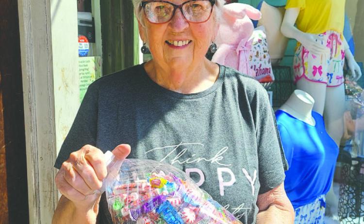 Jeanne Cook poses with candy jar from the Friends of the Library’s contest that will be held April 19-25 at the Guthrie Public Library.