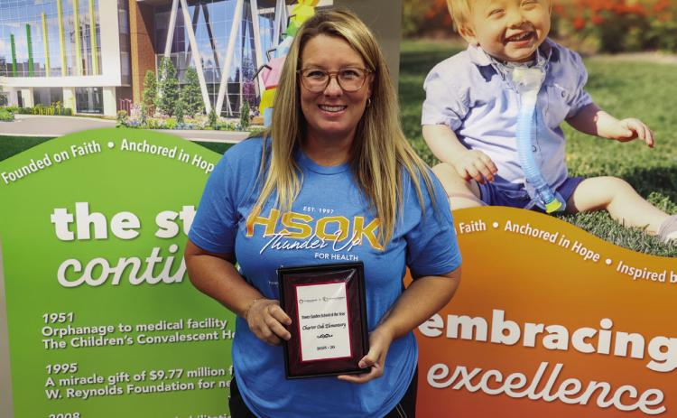 Aaron Harbin, P.E. teacher at Charter Oak Elementary accepted the Tower Garden School of the Year on July 29.
