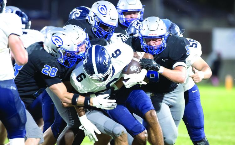 A host of Guthrie defenders take down an El Reno ball carrier during the Bluejays’ 42-0 win on Oct. 10 at Jelsma Stadium. The Guthrie defense limited the Indians to 50 yards of offense, including 15 yards through the air.
