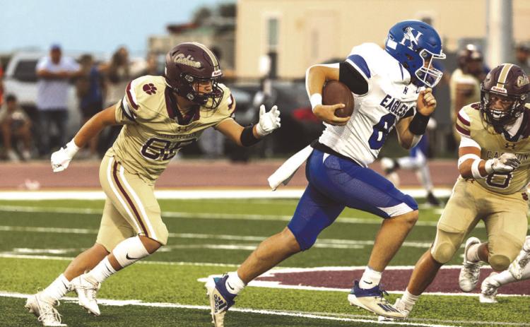 A pair of Cashon defenders chase a Hennessey running back during the Wildcats’ big win.