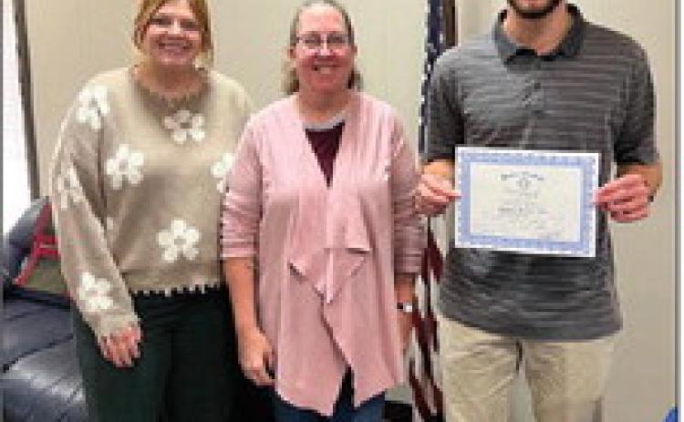 Pictured with Isaiah is Rotary President, Coy McPeek and Heidi Mallow, Director of Engagement with God’s Food Bank.