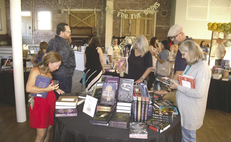 Shoppers browse hundreds of books during CASA for Kids' third annual Grown Up Book Fair at the Guthrie Depot on July 23. Photo courtesy of CASA For Kids.