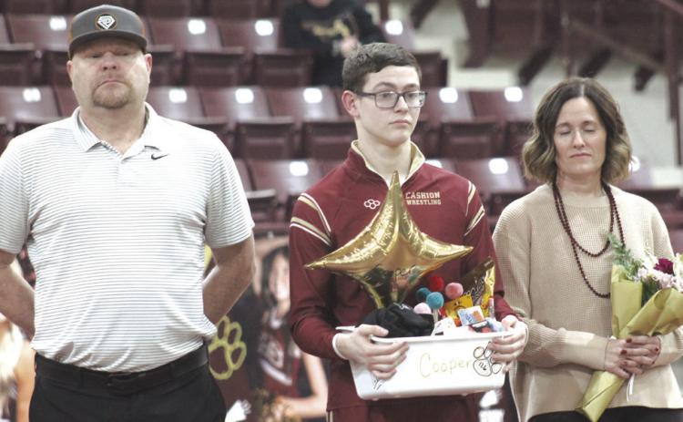 Cashion wrestling senior Cooper McGuire with his family on Senior Night. Photo by George McCormick