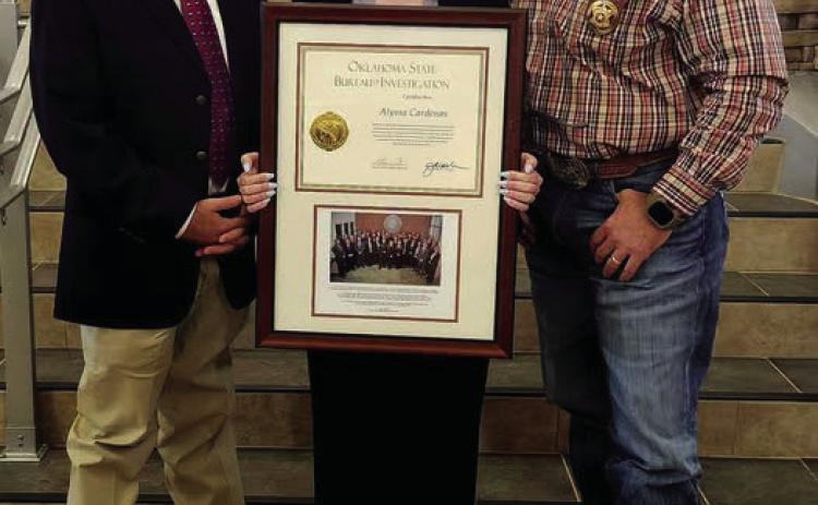 Alyssa Cardenas, a Logan County Sheriff’s Office investigator, celebrates completing the Oklahoma State Bureau of Investigation Agents Academy. Cardenas is pictured at graduation with Logan County Sheriff Damon Deveroux and Captain Bragg.