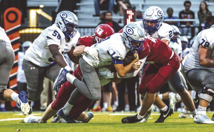 Guthrie quarterback Daelon Rice stretches for extra yardage as Tuttle defenders bring him to the ground. Guthrie players Sir’William Morgan(58) and Owen Wilder (78) are in on the play. Tuttle won 38-13.