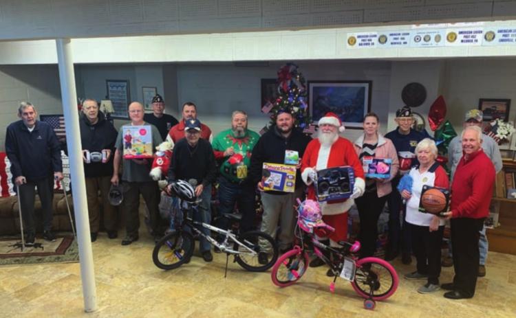 Greg Price (Adjutant), Larry Woods, Bob White, Steve Bowers, Charlie Downs, Jim Fry, Michael Manning (Sergeant of Arms), Patricia Mutters, Billy Weeks, Ryan Friesen, Ron Powell, Jerry Beranek and Mayor Steve Gentling at the American Legion Toy Drive.