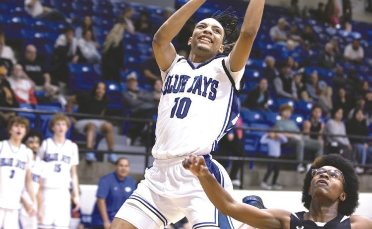 Guthrie’s Jahvari Harper (10) finishes at the rim against Harding Charter onTuesday, Feb. 17, 2026, in Guthrie, Okla. Guthrie won 67-6. Photo by Brent Fuchs.